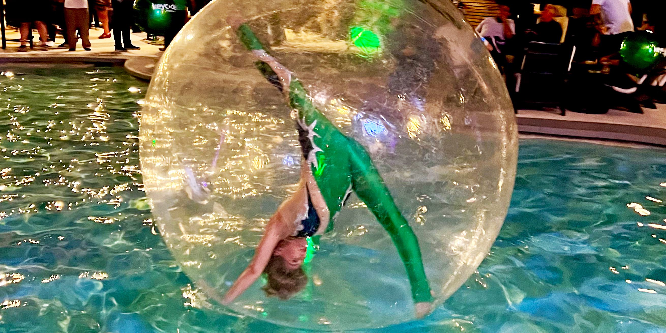 Water Sphere Contortionist Dazzles in Green at Las Vegas Corporate Event