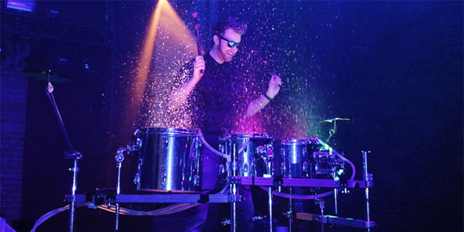 UV Water Drummer Amazes At Neon Nights Themed Party